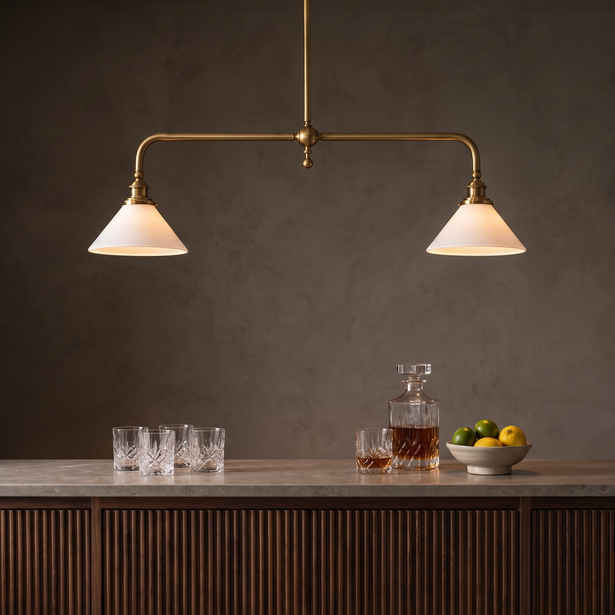 Halvenne Linear Brass Pendant Light Bar above a modern luxury home bar