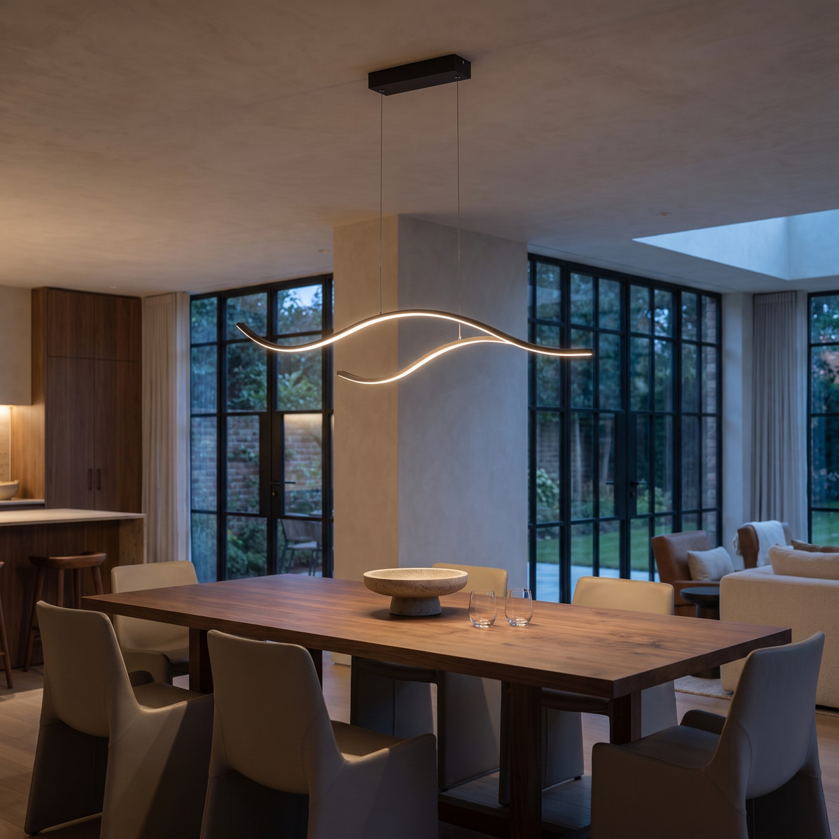Aurelis Wavy Linear LED Pendant Light in a modern luxury dining room