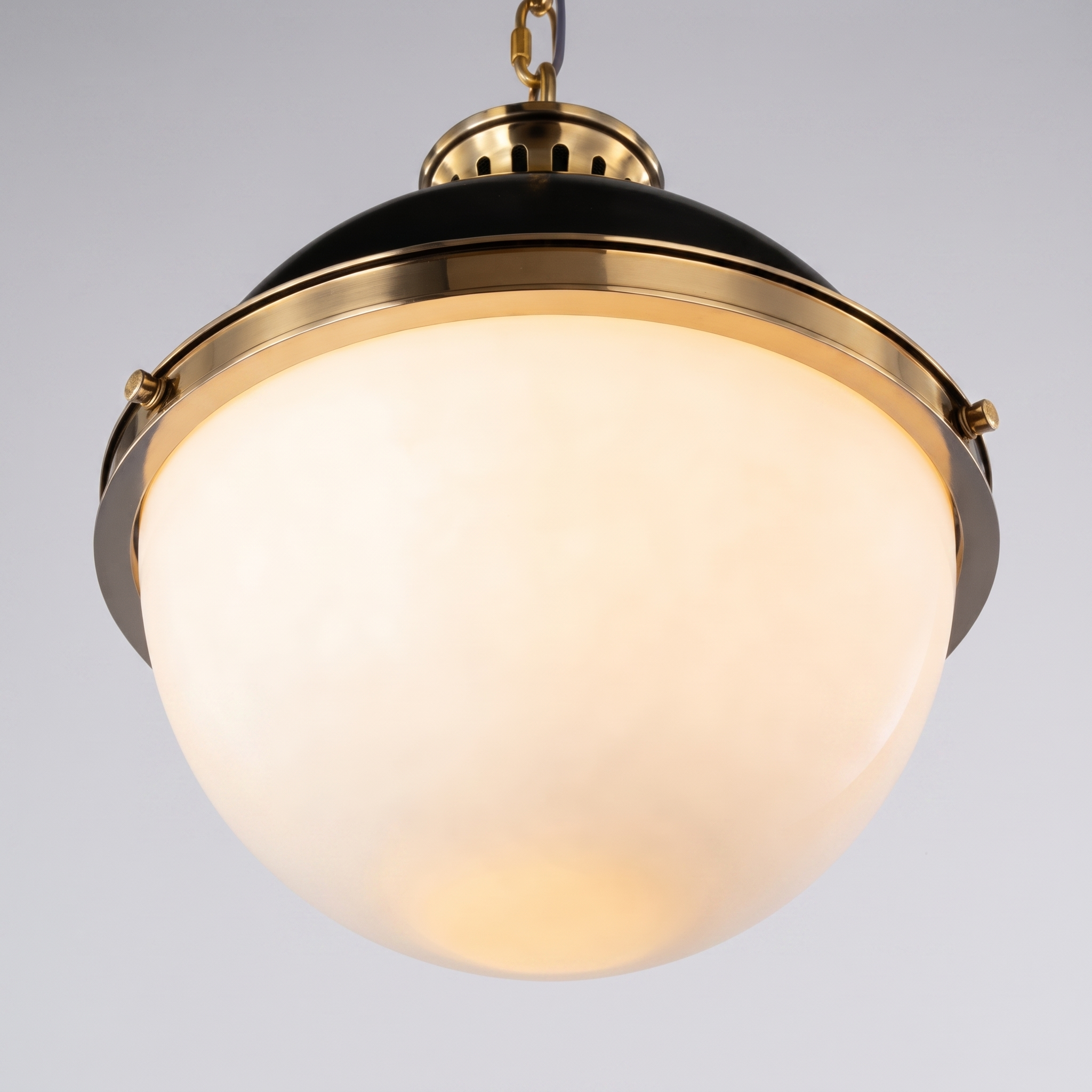 Close detail of the Belmoro frosted glass globe and gold hardware