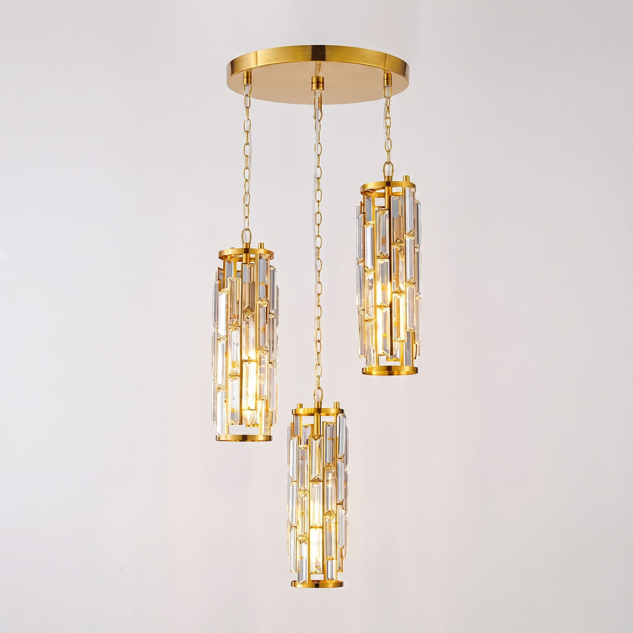 Gold Aurelique three-light crystal pendant studio shot
