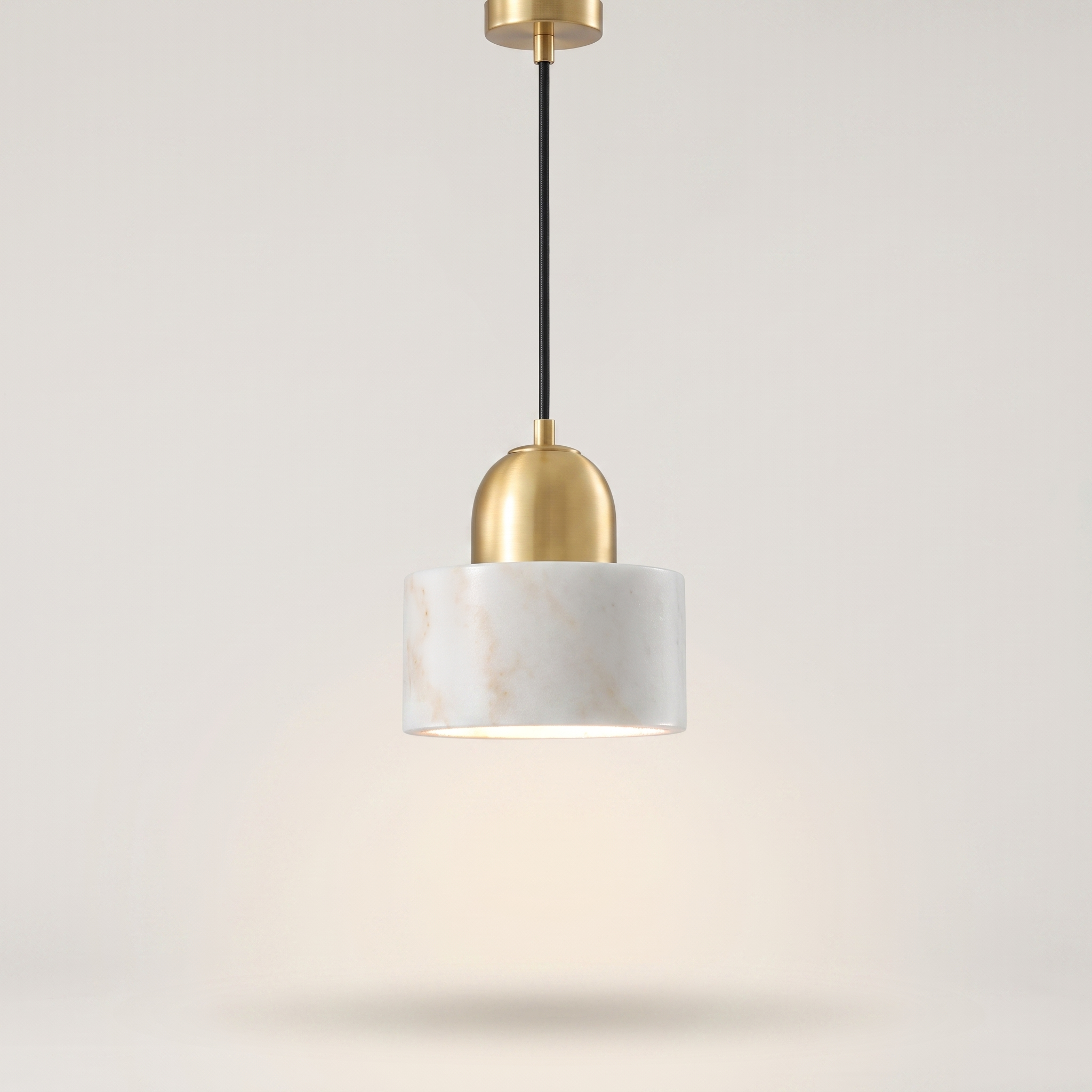 Marbelle pendant light above a stone dining table