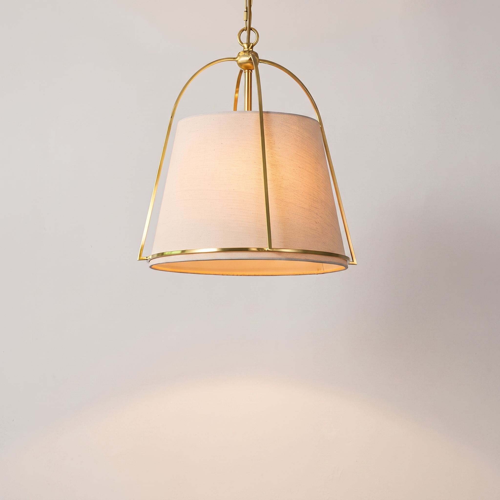 Trapelle gold trapezoid pendant above a luxury dining table