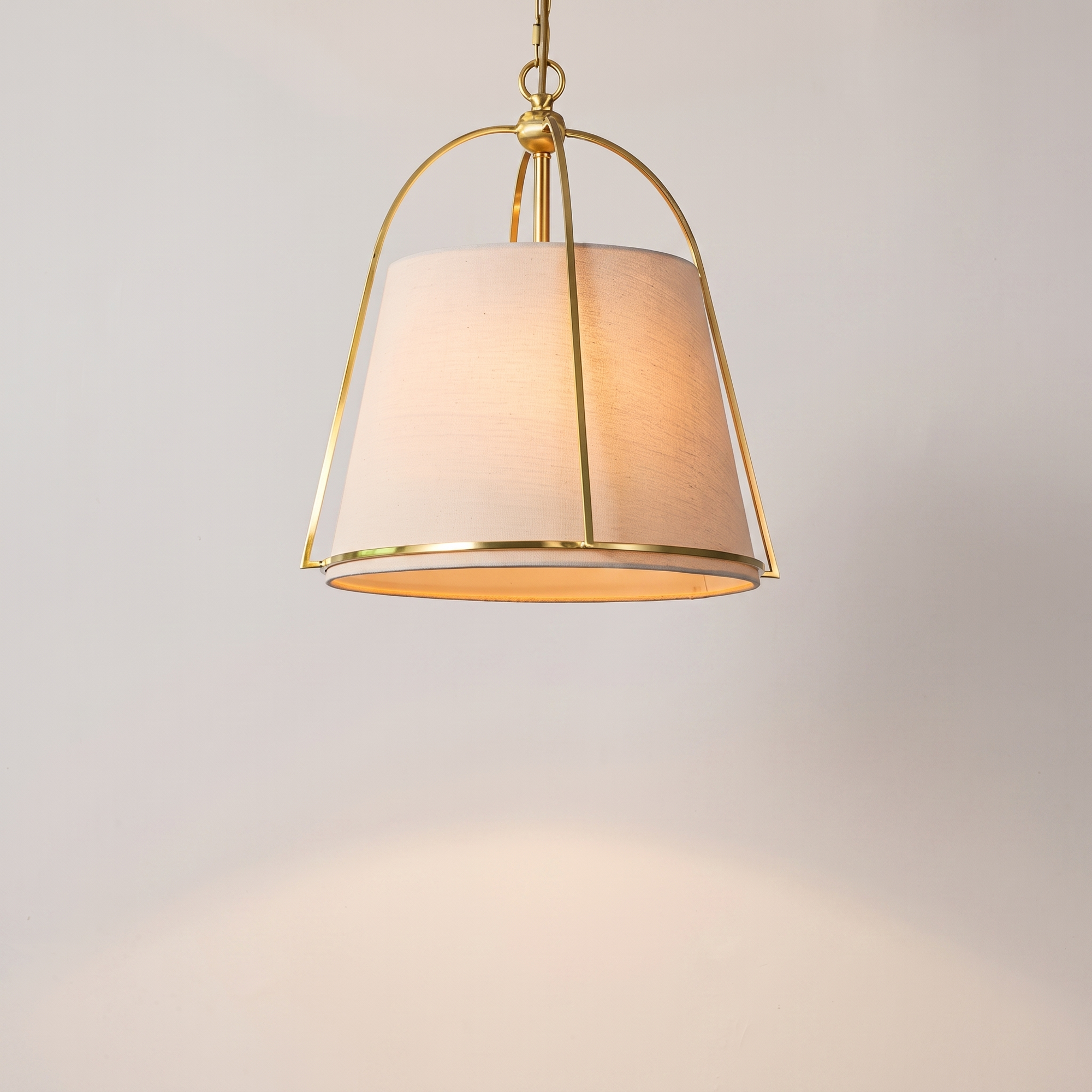 Trapelle gold trapezoid pendant above a luxury dining table