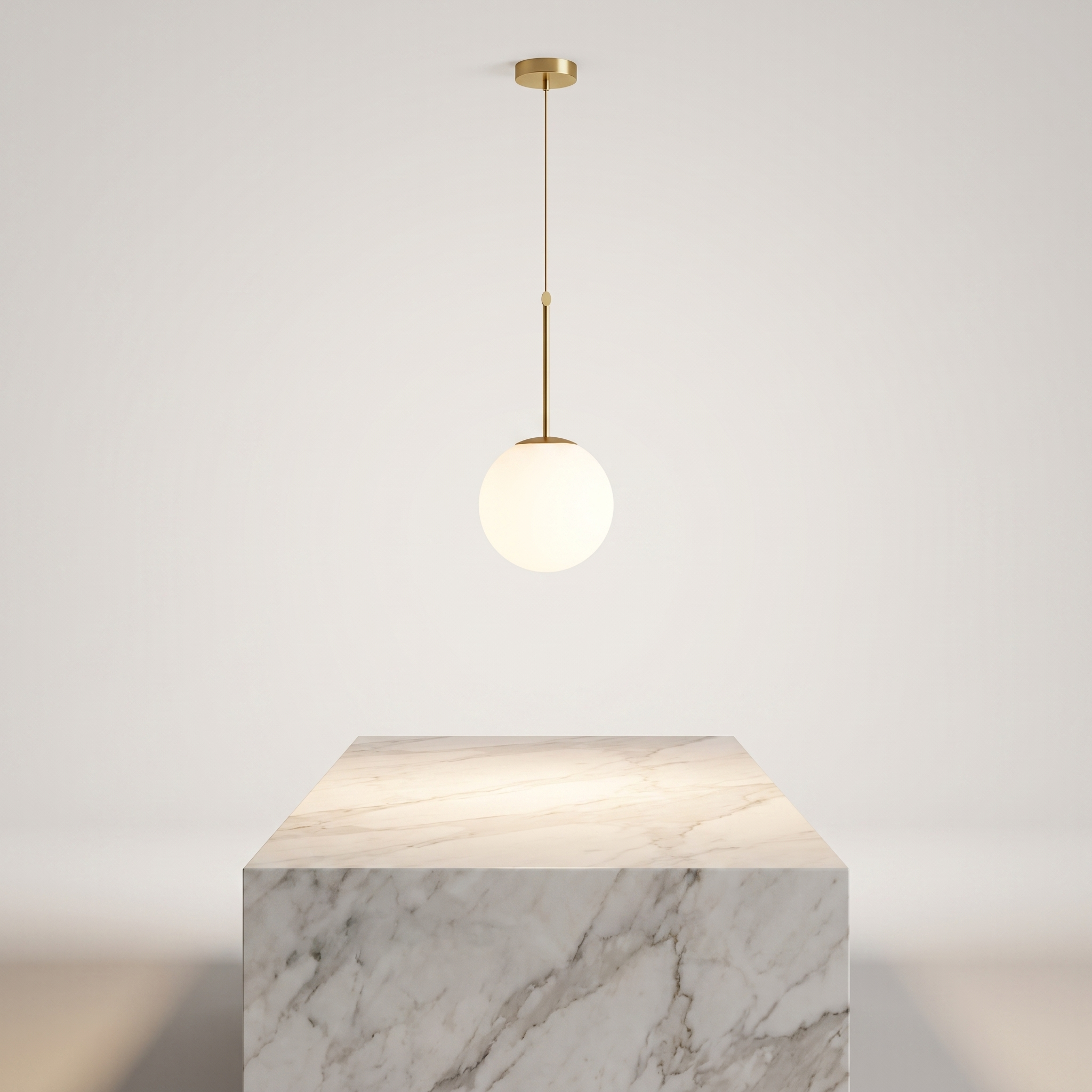 Insulara glass globe island pendant above a marble kitchen island