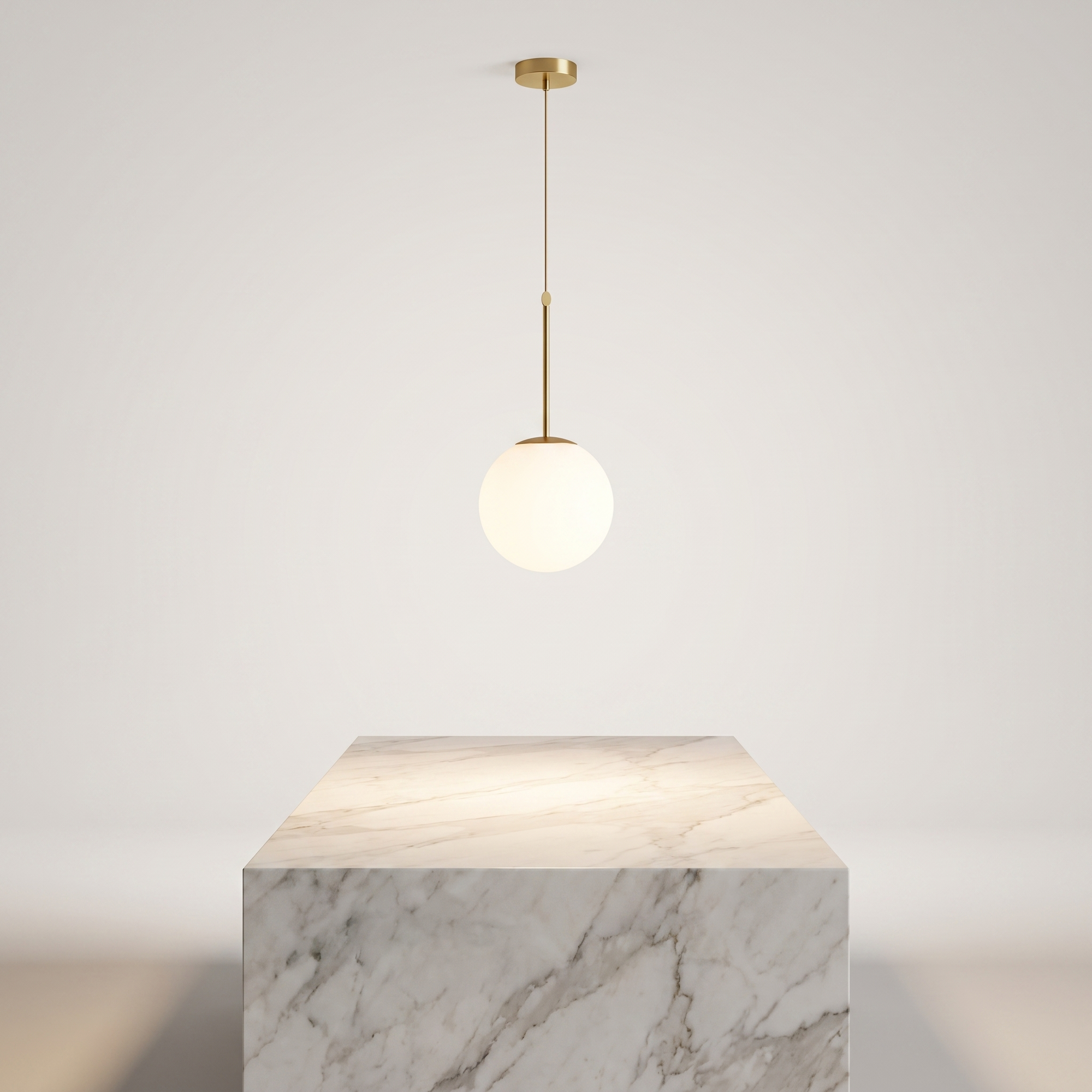 Insulara glass globe island pendant above a marble kitchen island